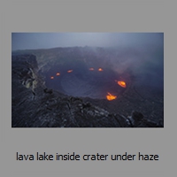 lava lake inside crater under haze